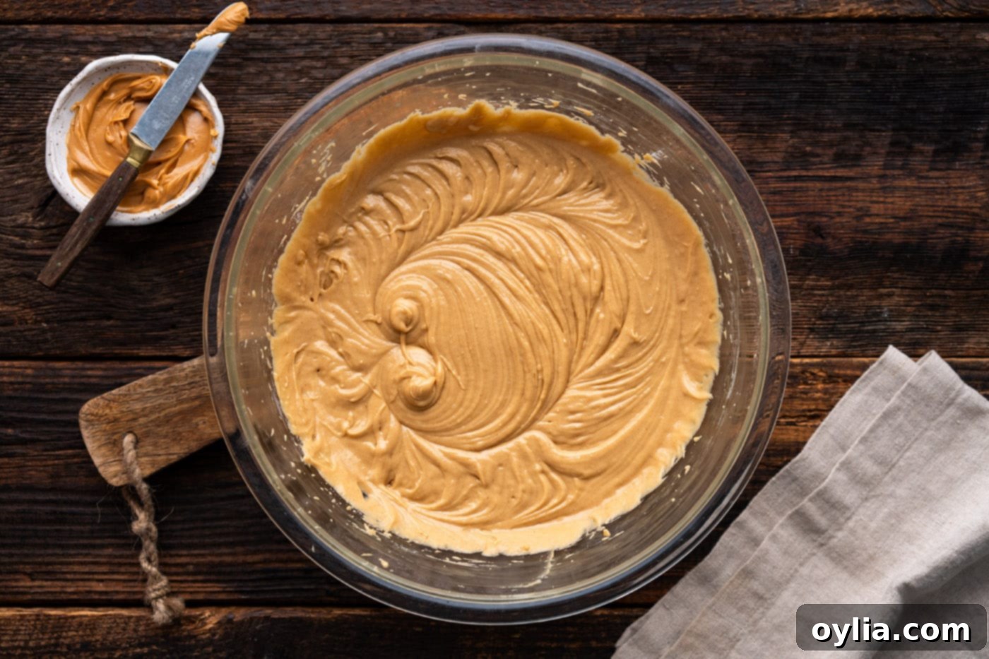 The fully mixed peanut butter bread batter in a bowl, showing a smooth and slightly thick consistency.