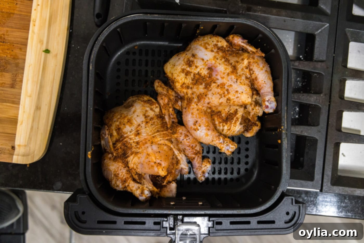 two cornish hens in an air fryer basket