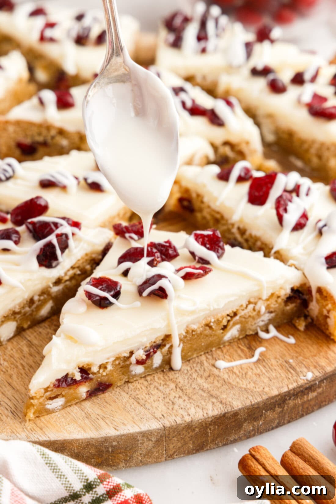 White chocolate bring drizzled over a Cranberry Bliss Bar