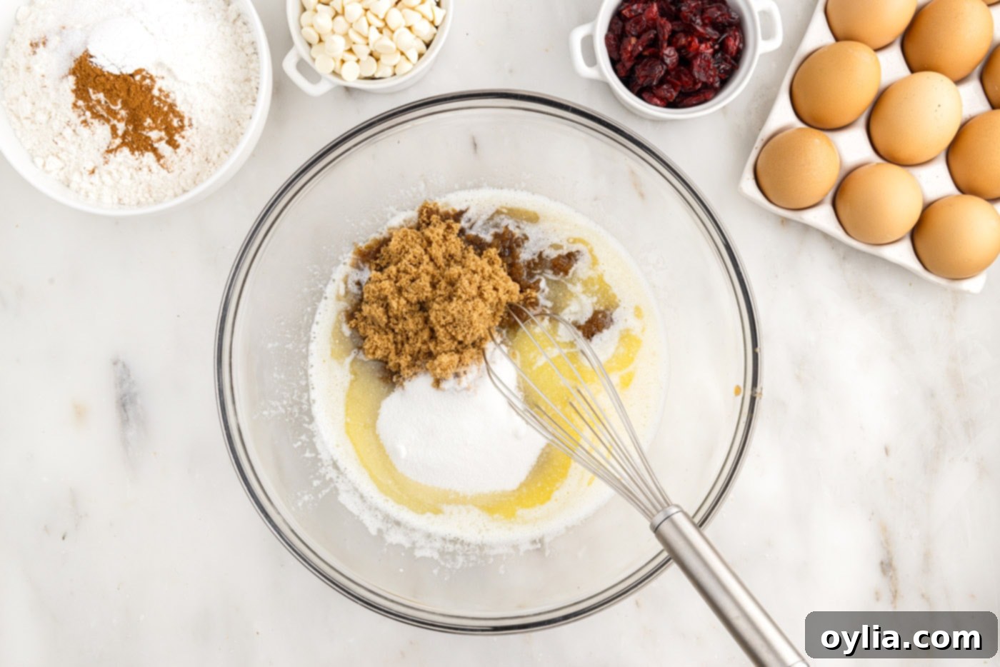 melted butter and sugars in a bowl with a whisk