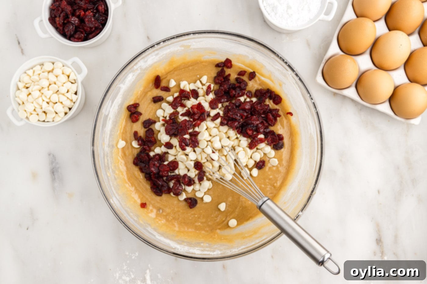adding dried cranberries and white chocolate chips to blondie batter