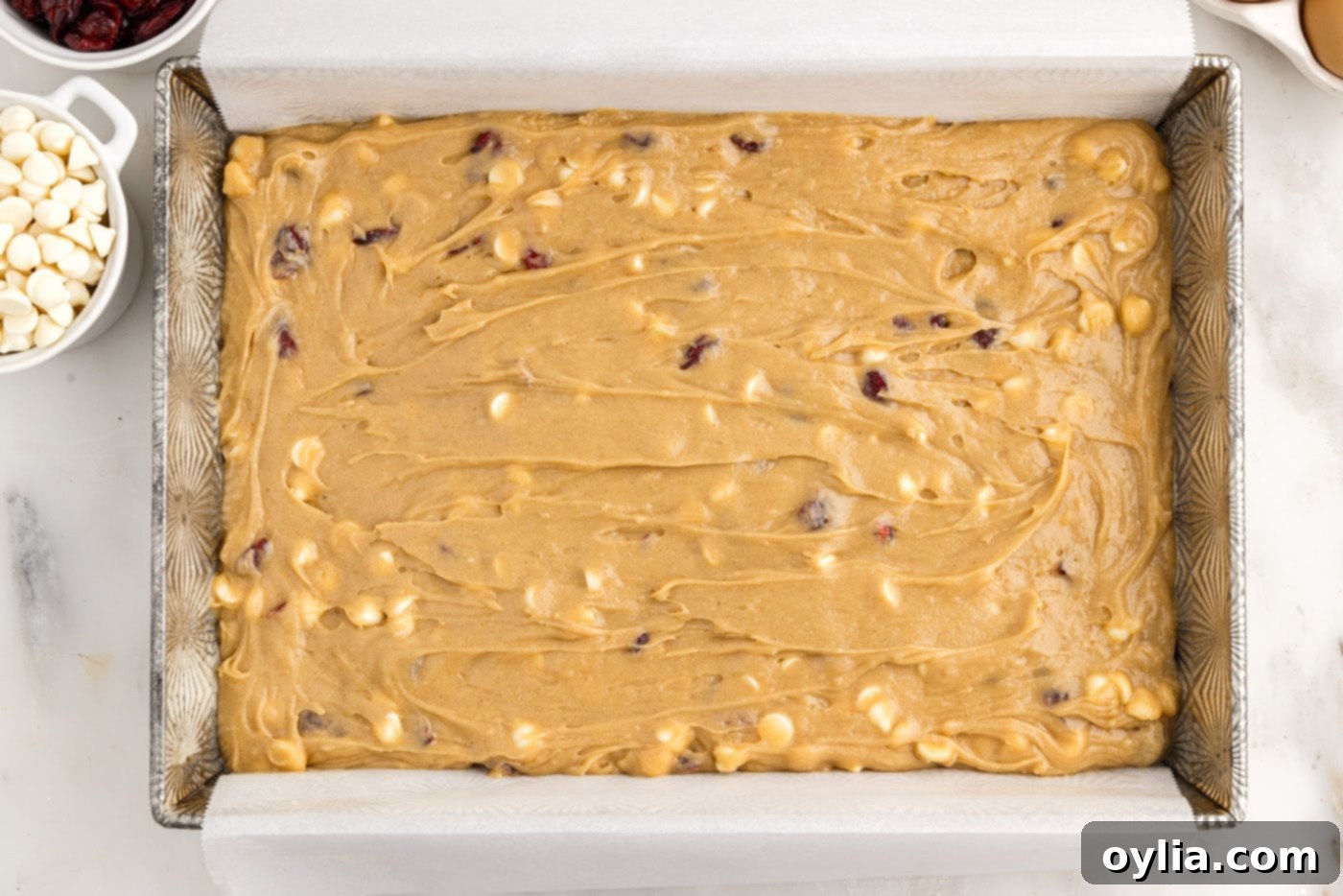 white chocolate cranberry blondies in a baking pan