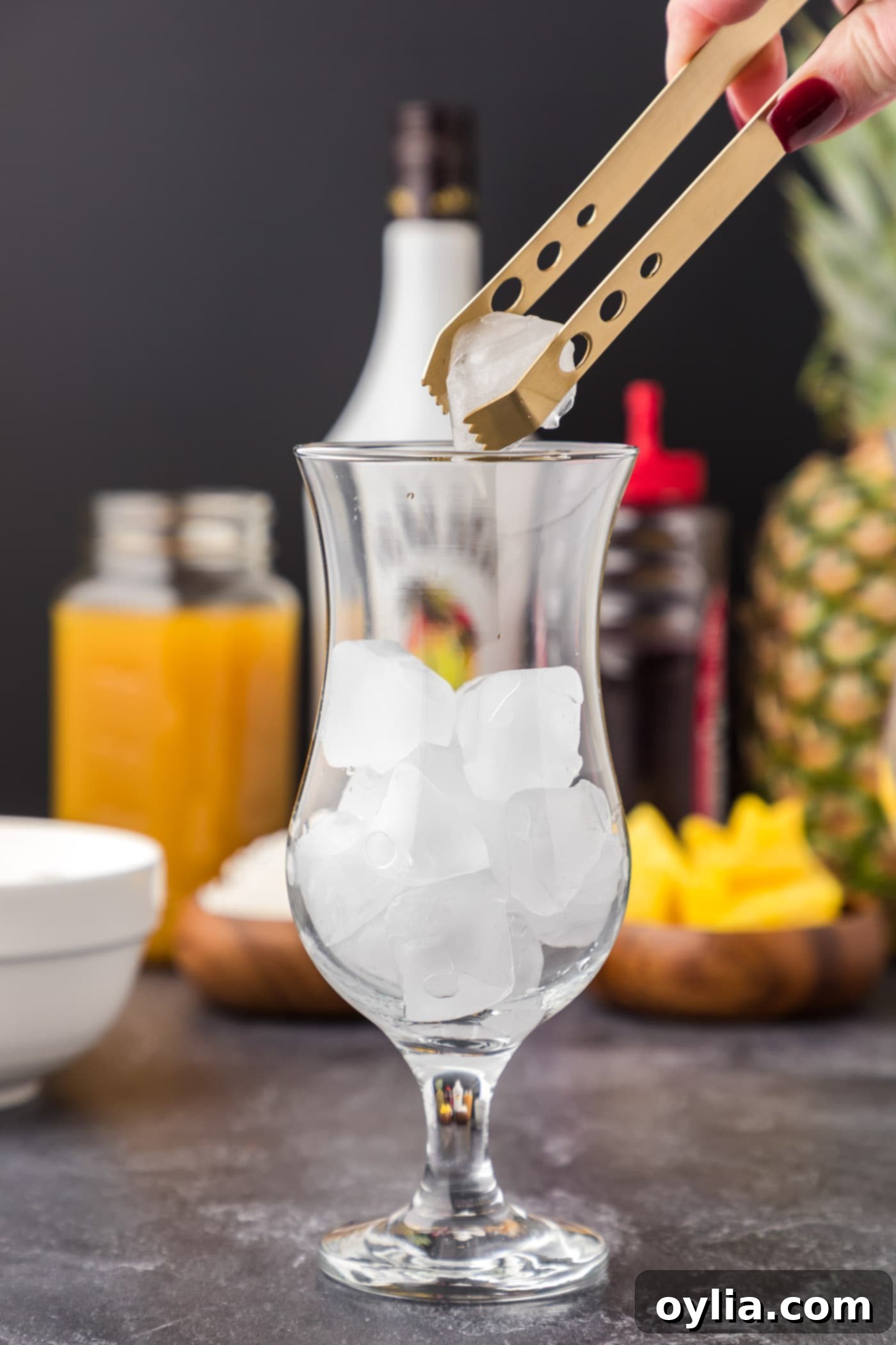 adding ice cubes to hurricane glass