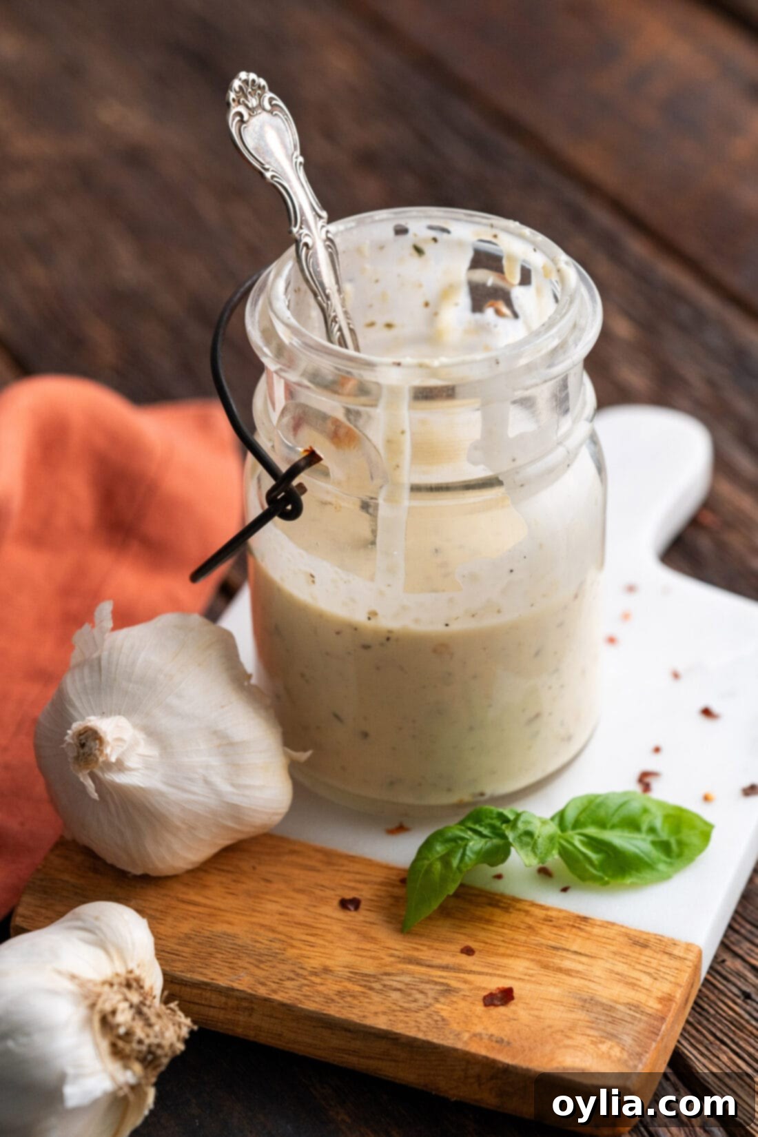 Jar of Homemade Garlic Parmesan Wing Sauce, rich and creamy, ready for use.