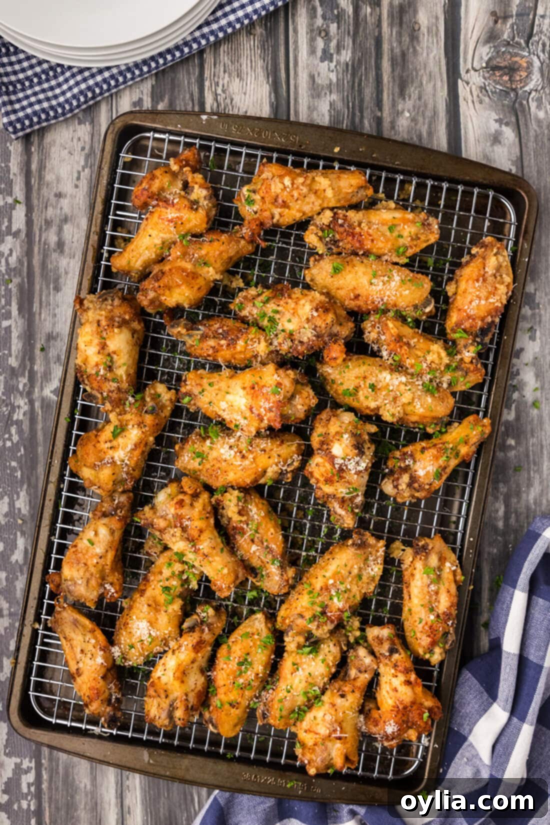 Crispy golden-brown Garlic Parmesan Wings resting on a wire rack, ready to be sauced.
