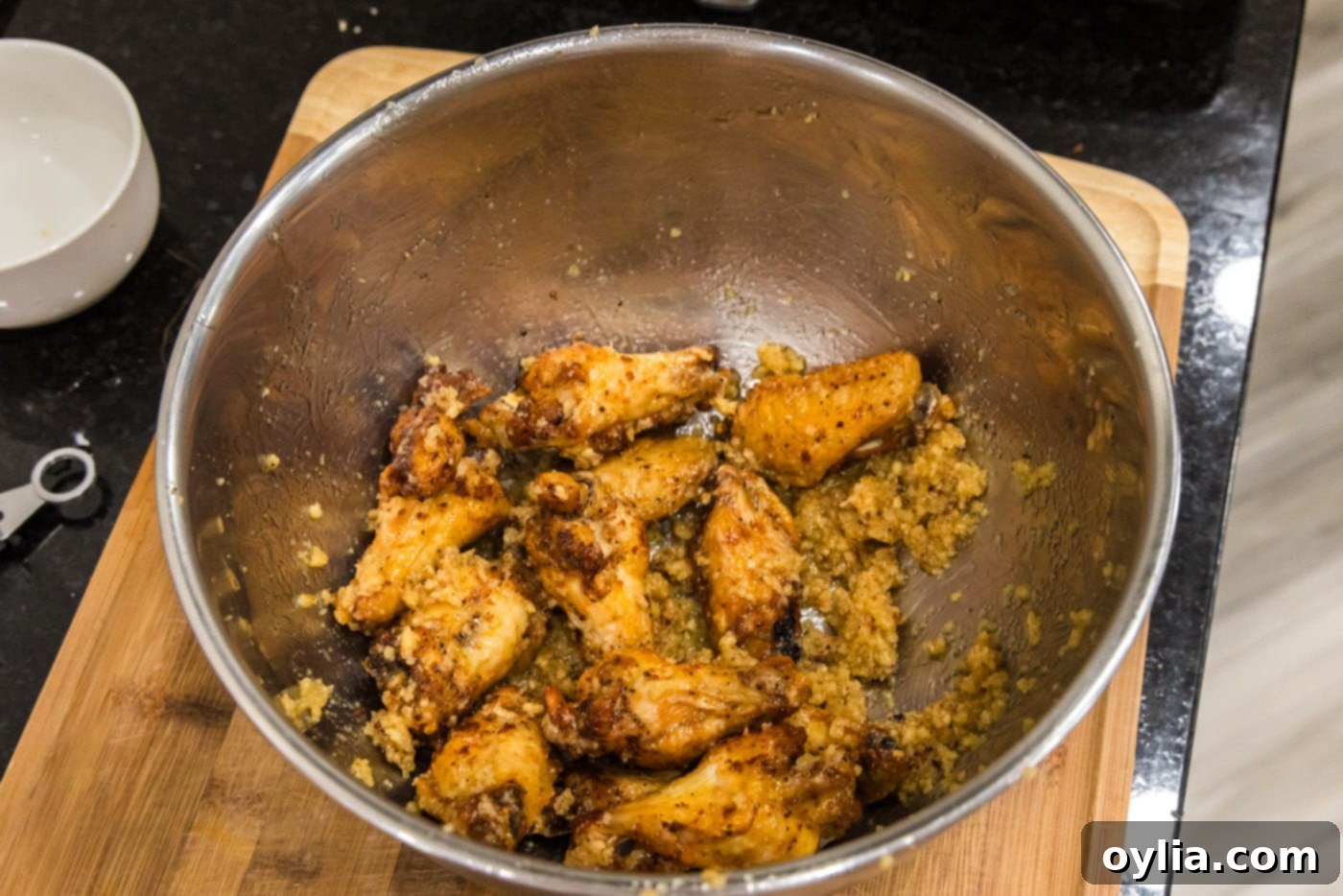 Easy garlic parmesan wings coated in rich, buttery sauce, ready to be served.