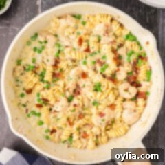Close up photo of a skillet of Chicken and Shrimp Carbonara