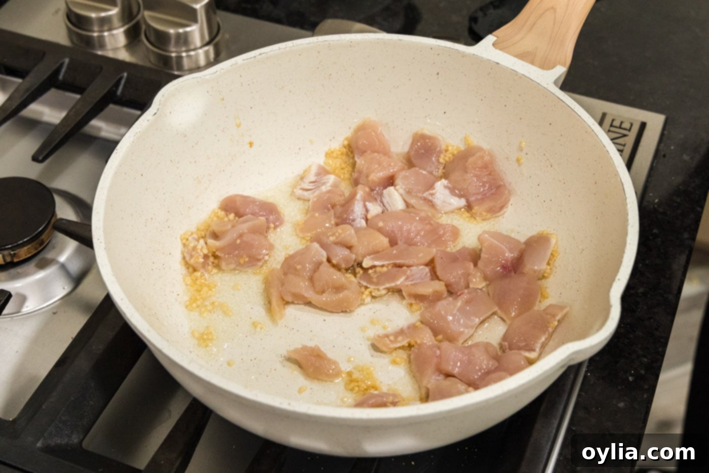 chicken in skillet with oil