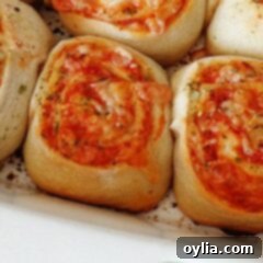 Easy Pizza Spirals 12 A close up photo of cheesy pizza roll ups.