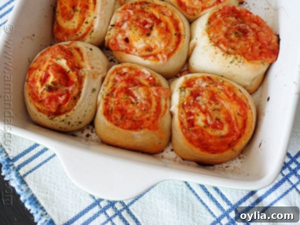 Detailed close-up showing the cross-section of a sliced pizza roll up, revealing layers of dough, sauce, and melted cheese.