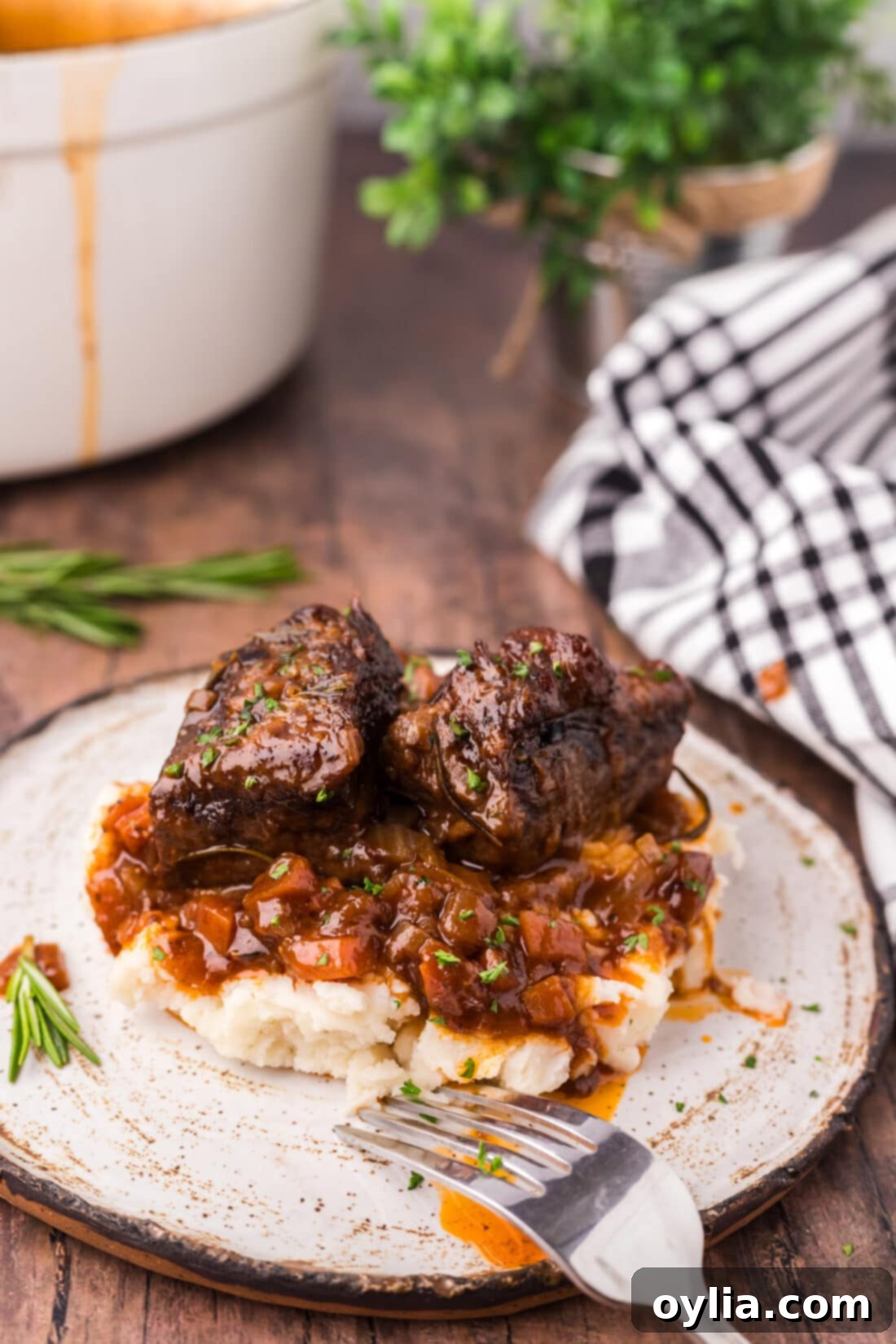 Perfectly braised beef short ribs served over creamy mashed potatoes, generously drizzled with rich red wine sauce.