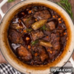 A pot of rich, tender Braised Beef Short Ribs in red wine sauce, ready to be served.