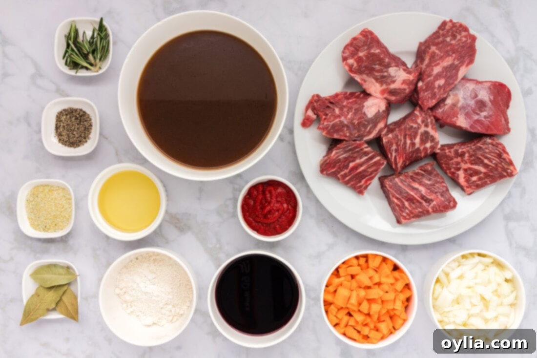 All the fresh ingredients laid out for making delicious braised beef short ribs: short ribs, carrots, onions, olive oil, flour, red wine, beef broth, tomato paste, garlic salt, black pepper, rosemary, and bay leaves.