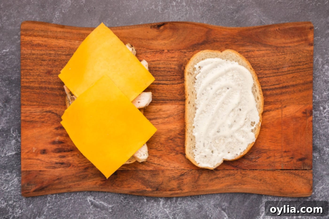 sliced cheese over the top of sliced chicken and ranch dressing