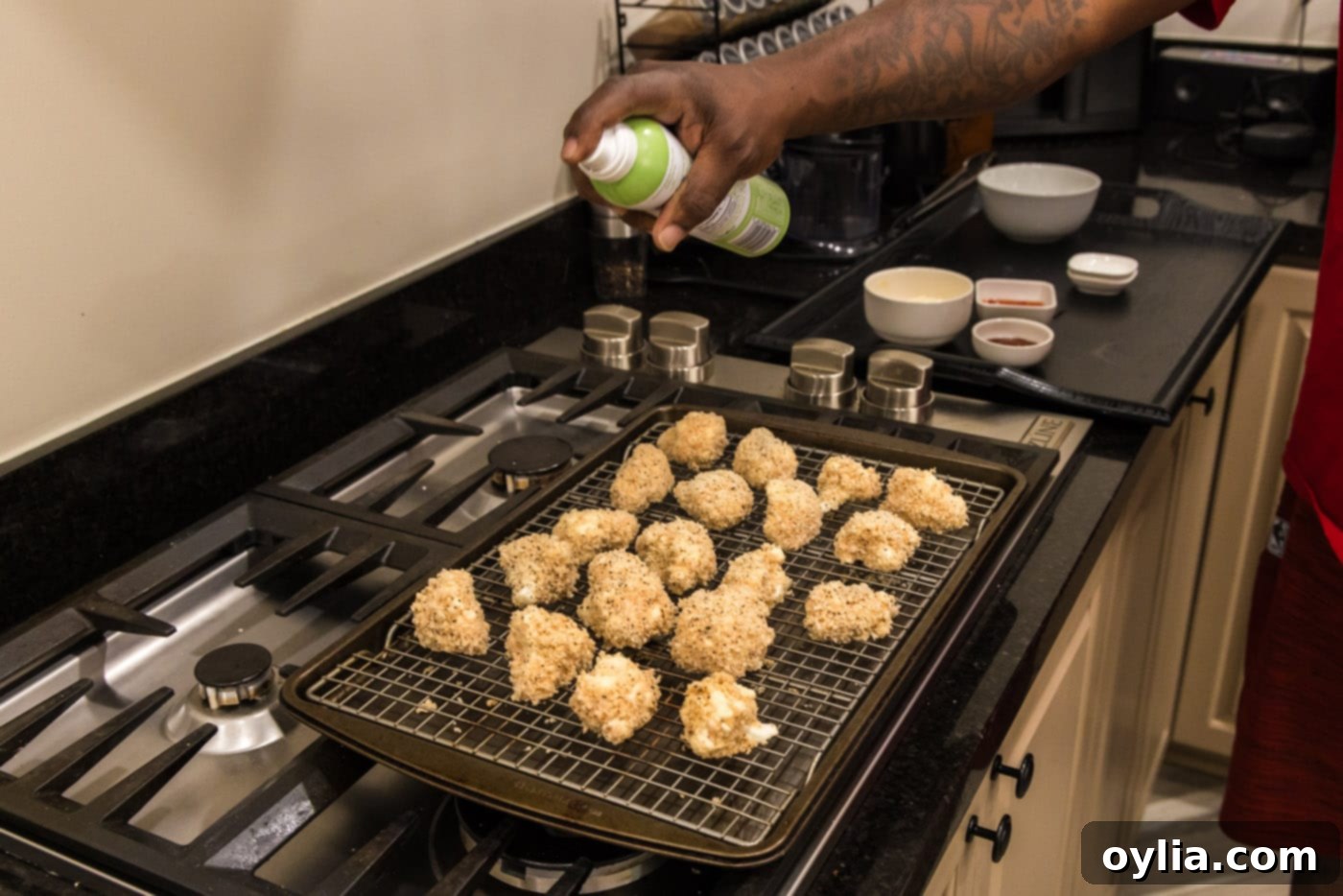 spraying bang bang cauliflower with olive oil spray