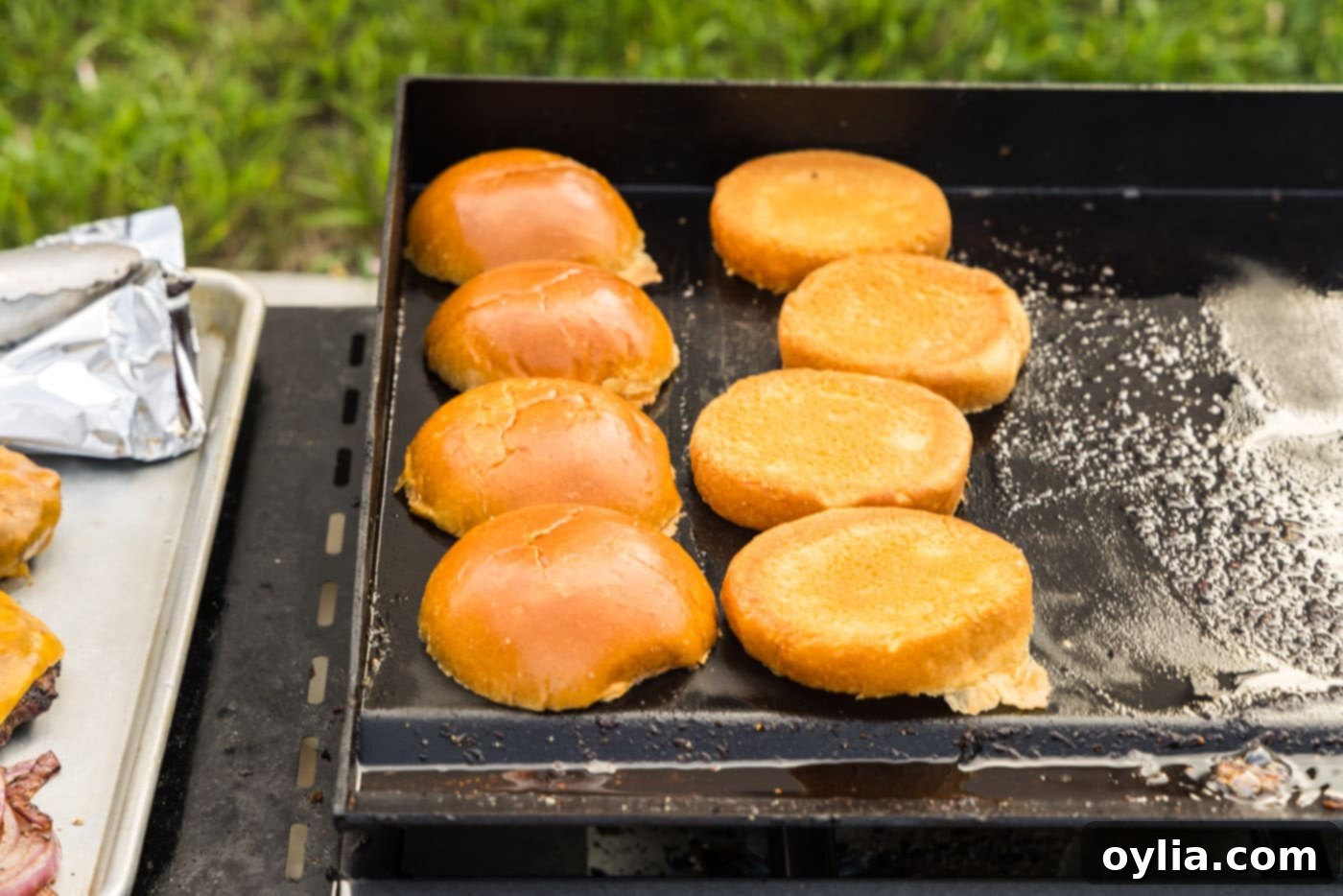 toasting burger buns on a grill