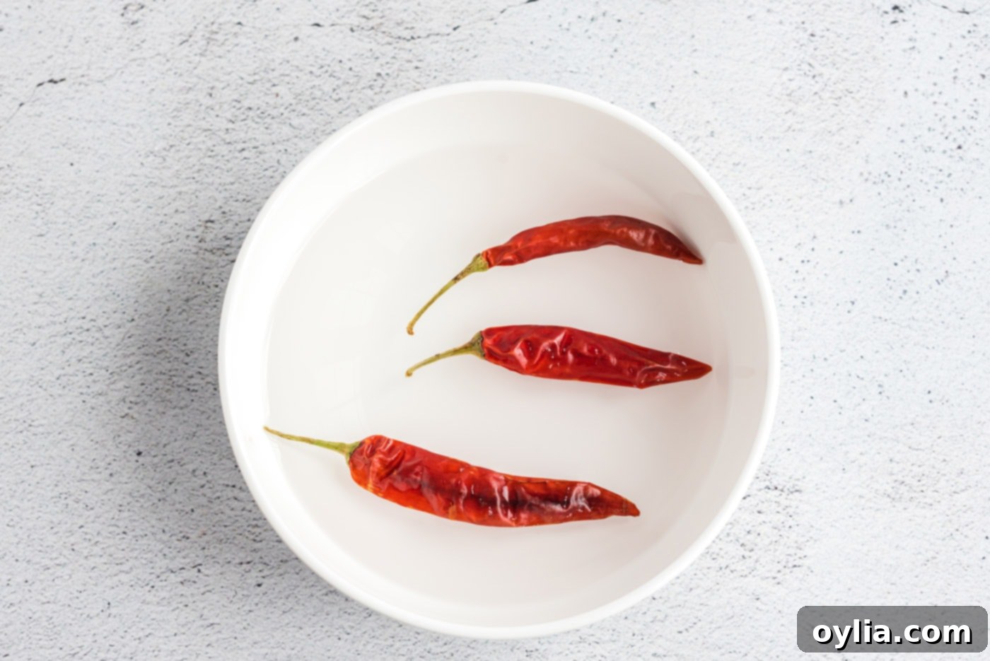 red chiles in a bowl of water