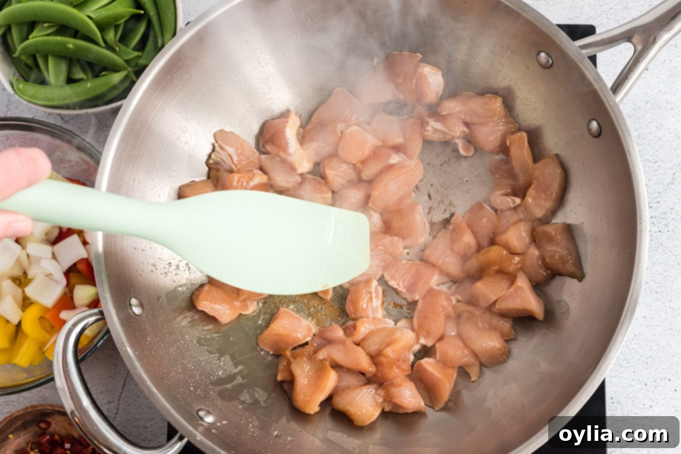 chicken in a wok pan frying