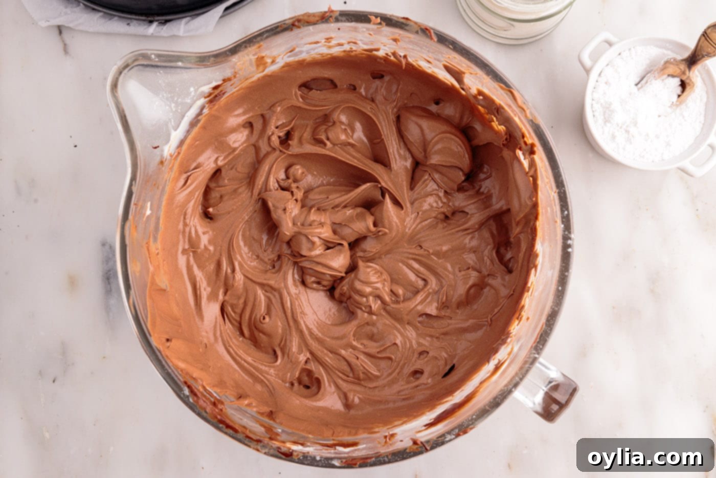 The finished, perfectly fluffy and well-combined chocolate cheesecake mixture resting in a mixing bowl, showcasing its readiness for chilling.