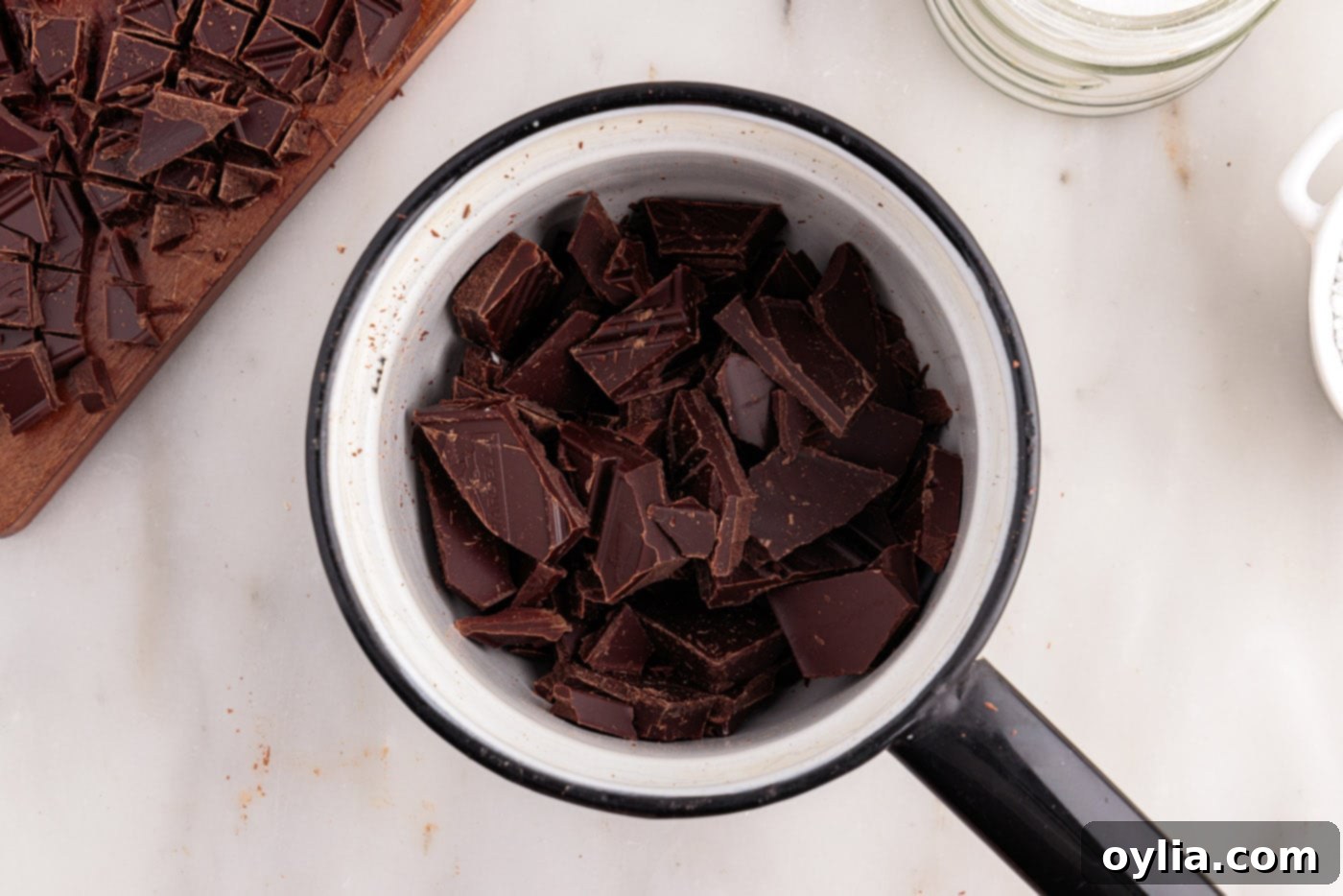 Chopped bittersweet and semi-sweet baking chocolate precisely measured and placed in the top pan of a double boiler, ready for melting.