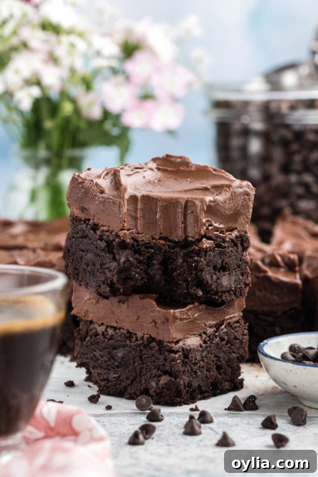 Stack of Fudge Frosted Espresso Brownies with a bite taken out of the top one