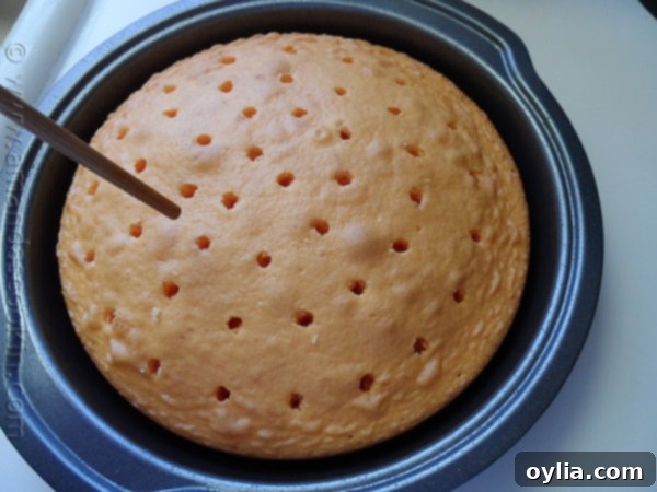 Step-by-step image: Preparing the orange cake mix in a large mixing bowl, a crucial first step for the poke cake.