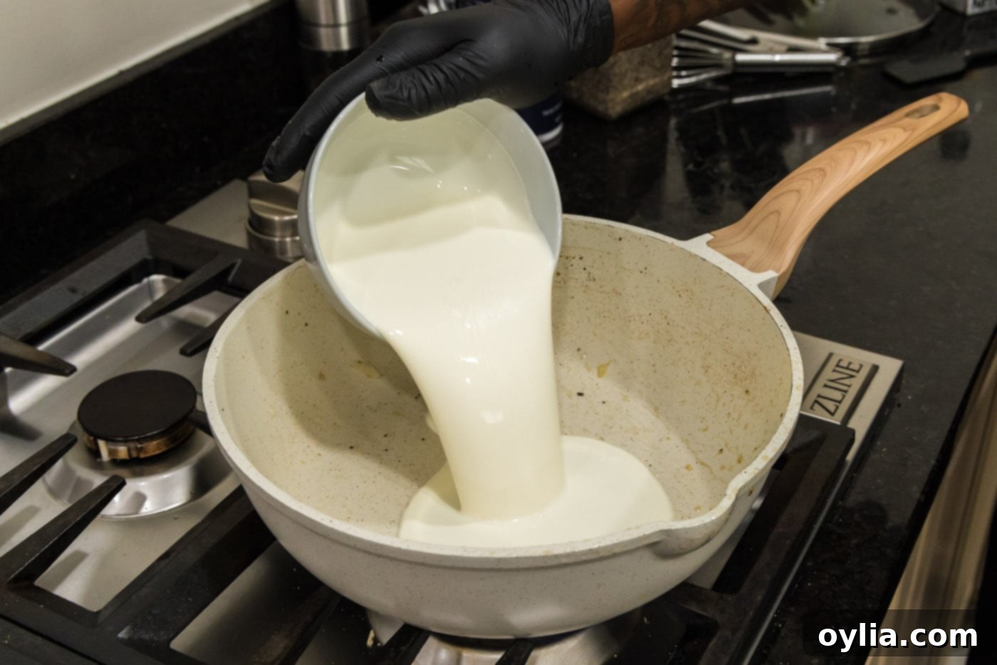 pouring heavy whipping cream into skillet