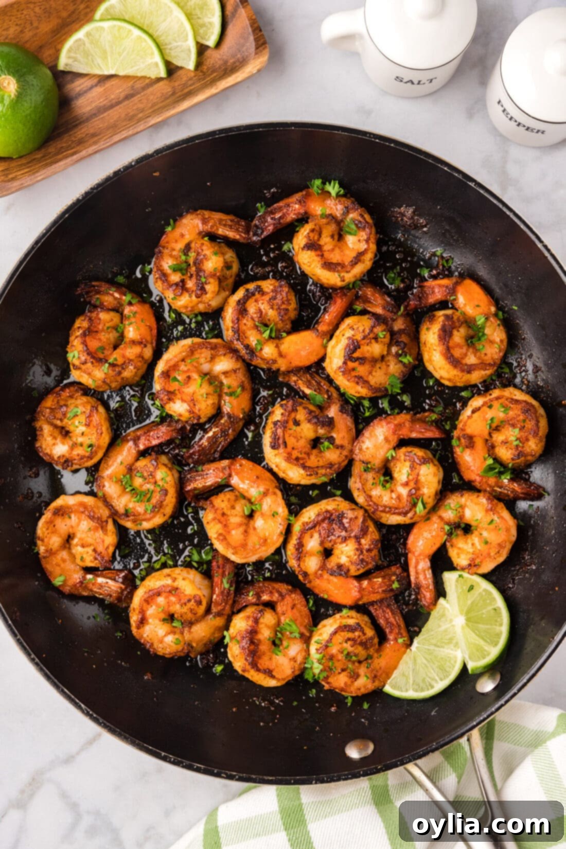 Close up photo of a skillet of Spicy Shrimp, perfectly seared and coated in vibrant spices