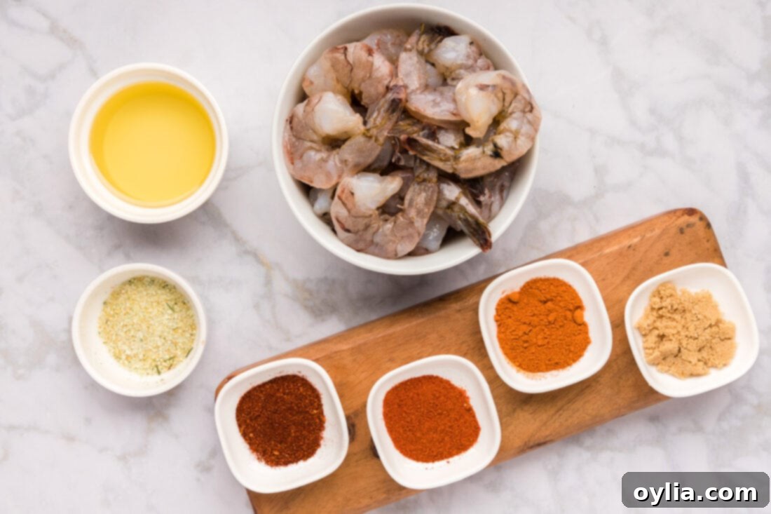 Collection of fresh ingredients for making Spicy Shrimp on a wooden board