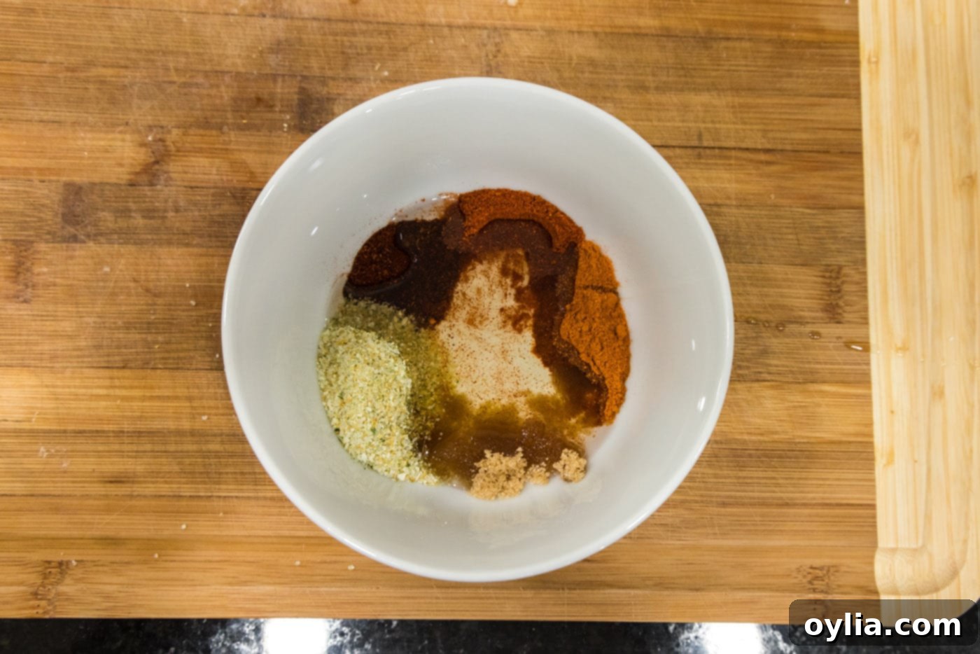 Olive oil with seasonings in a bowl, showing the initial mixture