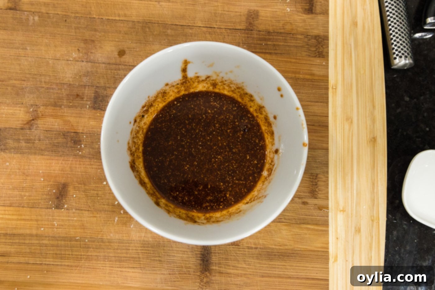 Spicy shrimp spice mixture in a bowl, now fully mixed into a paste
