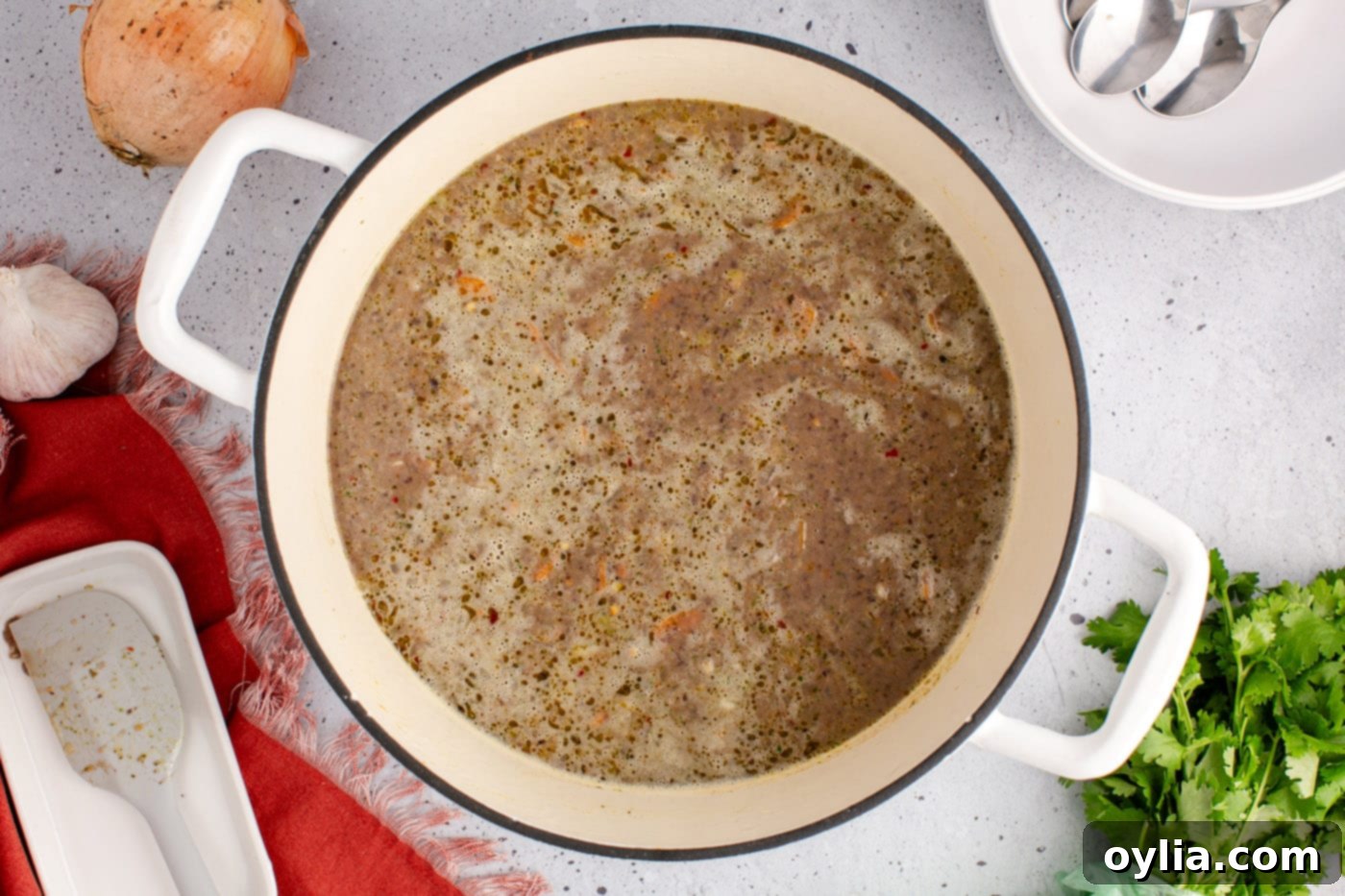 Creamy and rich black bean soup in a pot, steaming and ready to be served.