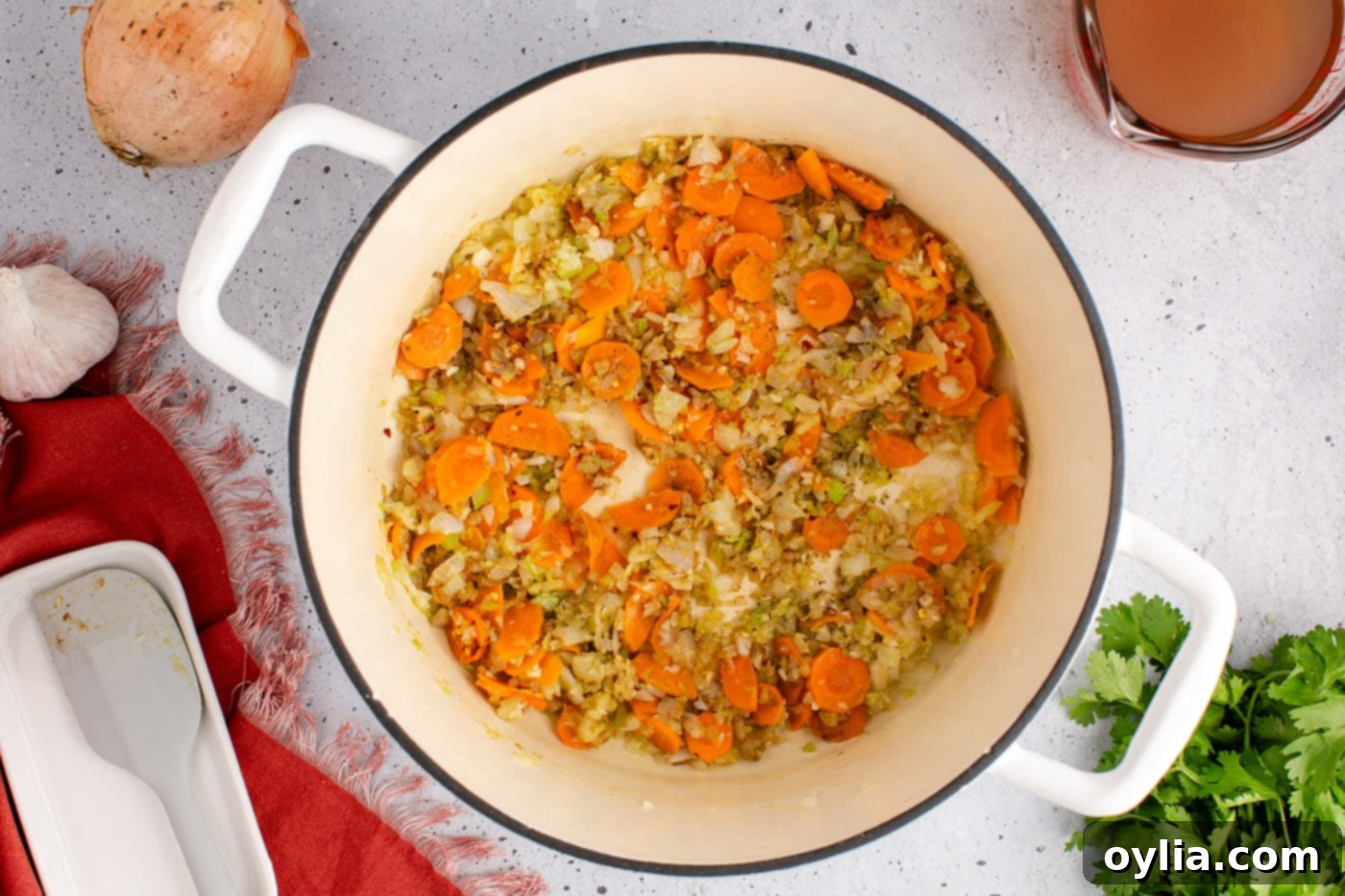 Seasoned vegetables in a soup pot, thoroughly mixed with aromatic spices.