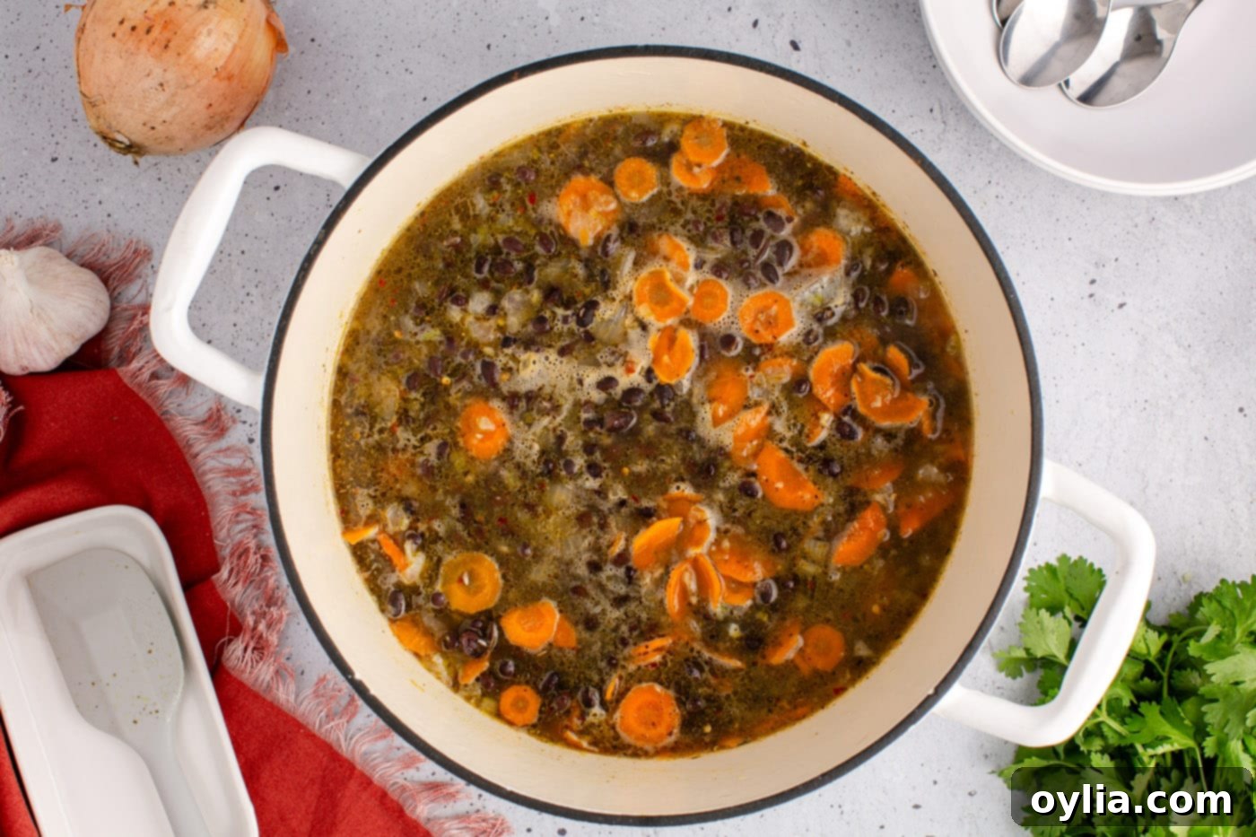 Cooked black bean soup simmering in a pot, rich and aromatic.