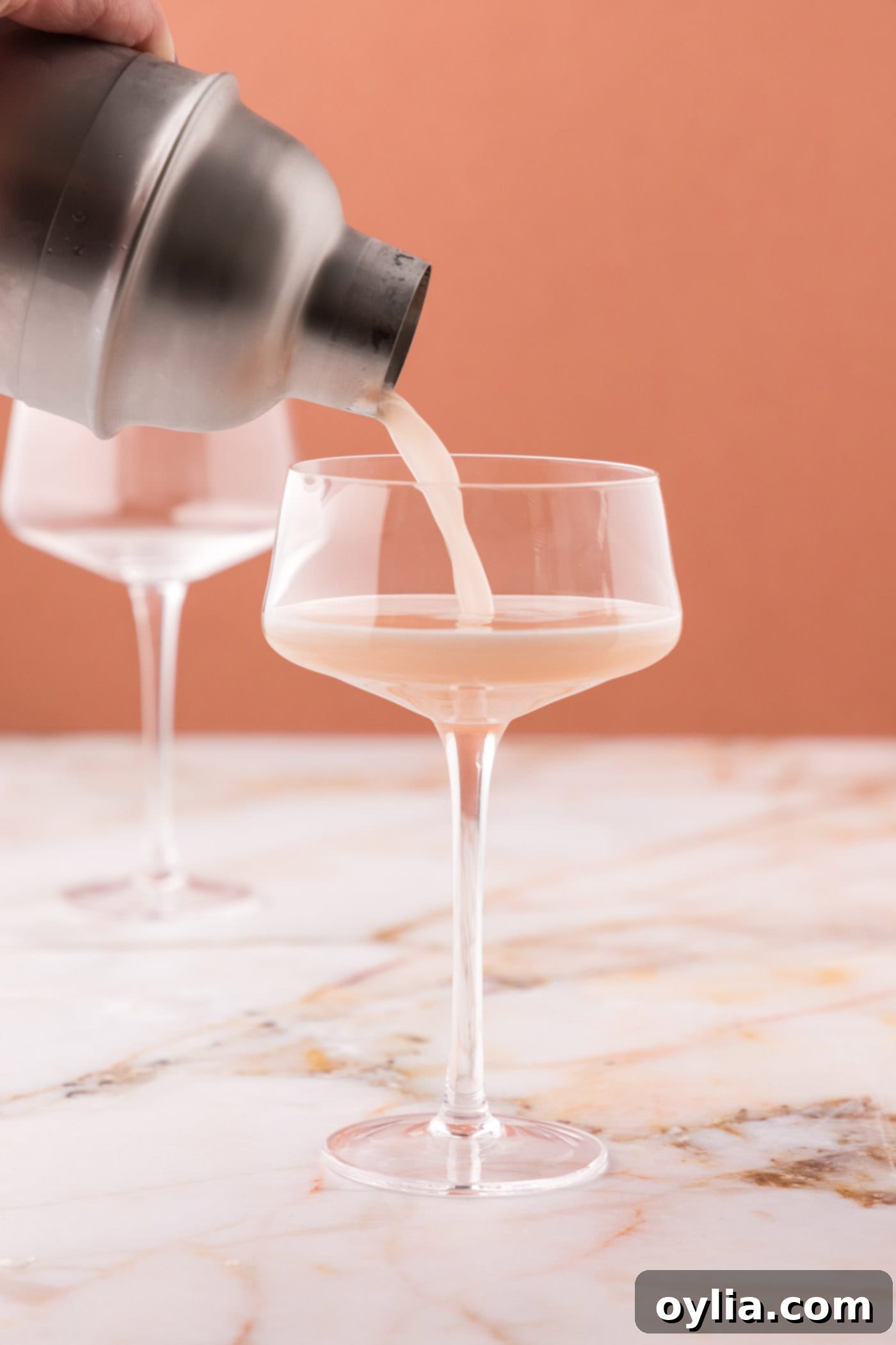 straining french martini into a glass