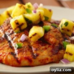 A close up photo of pork chops al pastor made on the grill.