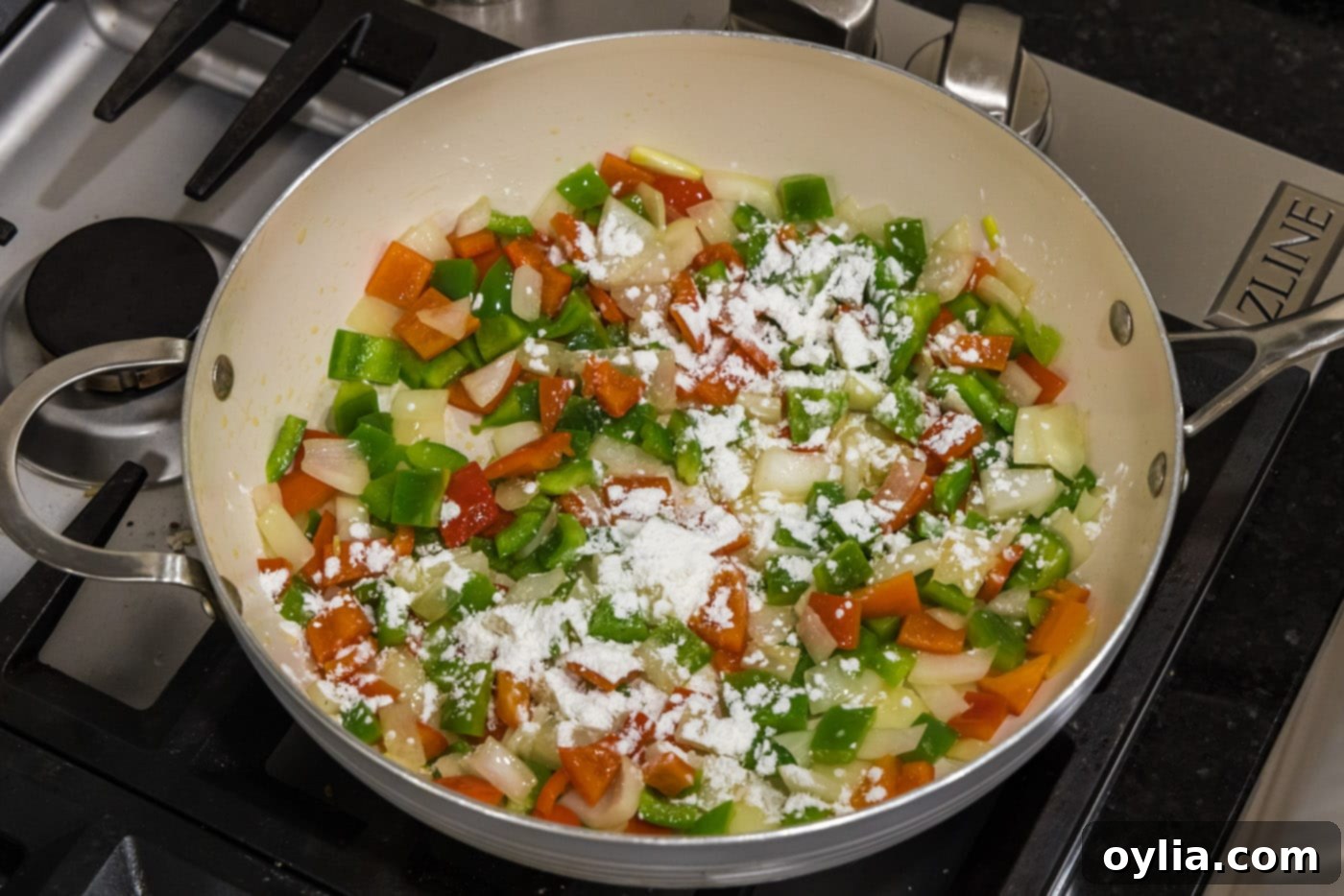 cornstarch sprinkled over chopped vegetables in a skillet