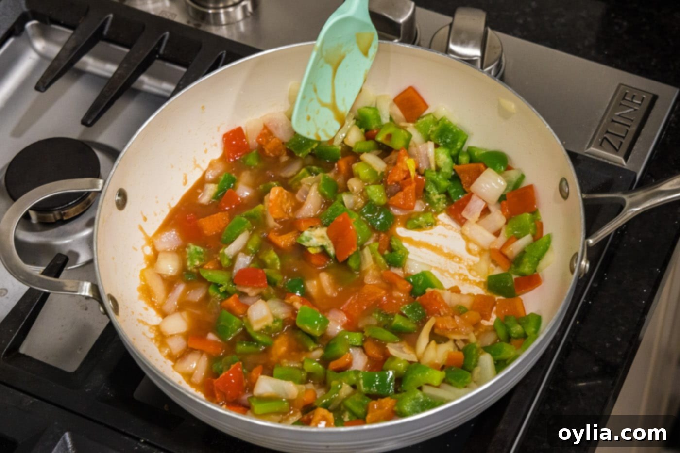 stirring sweet and sour sauce into vegetables in a pan