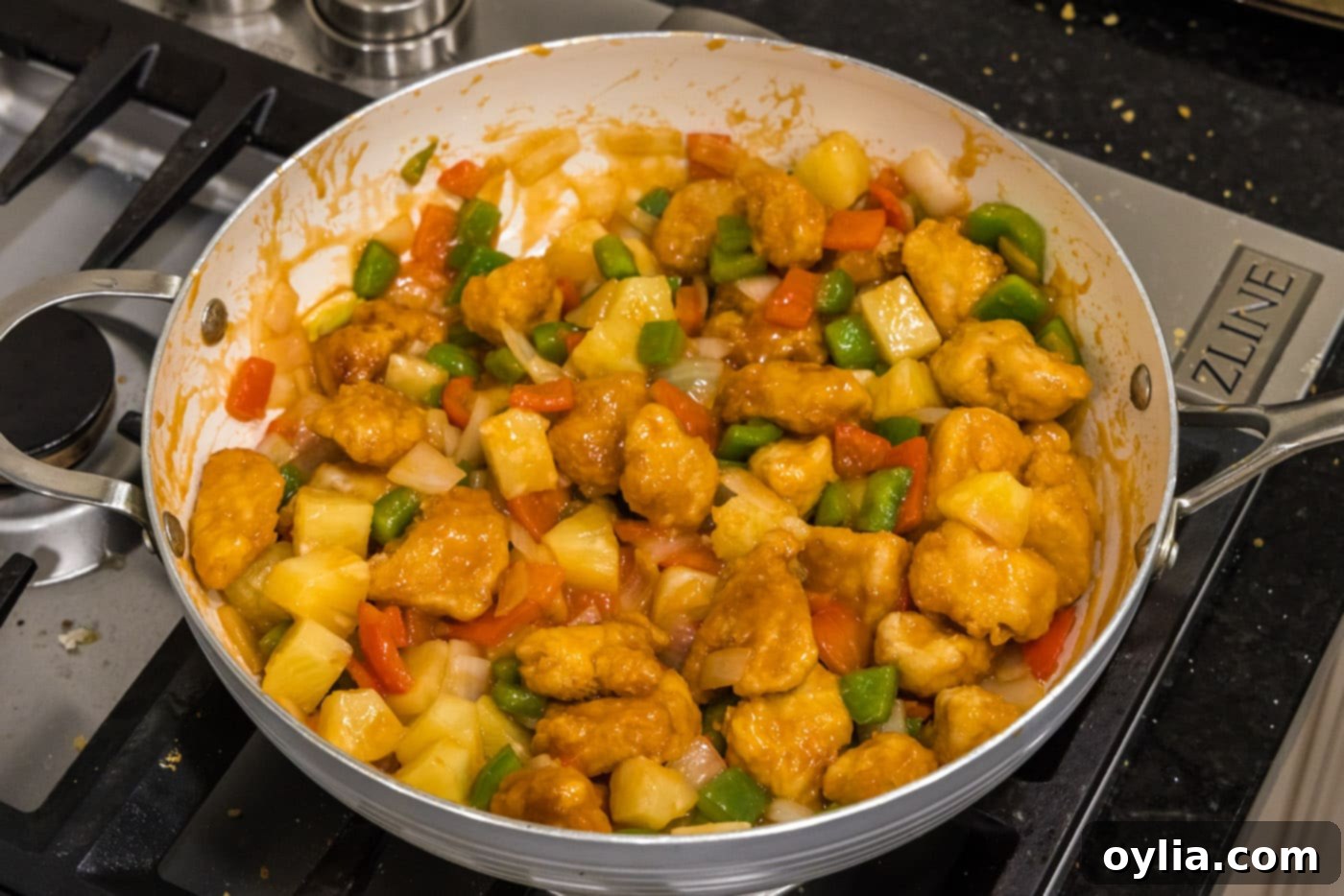 finished sweet and sour chicken with pineapple in a skillet
