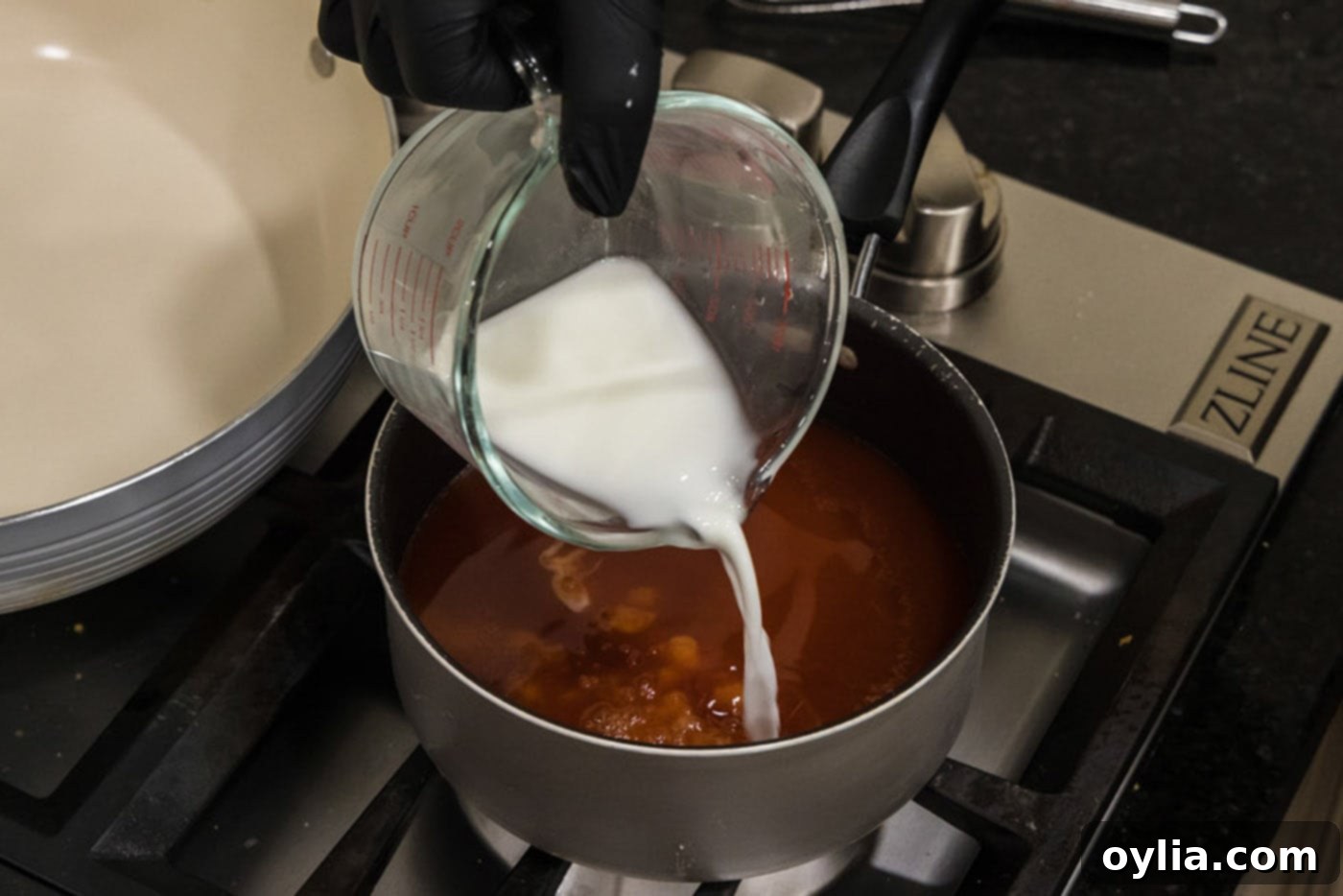 pouring cornstarch slurry into sweet and sour sauce