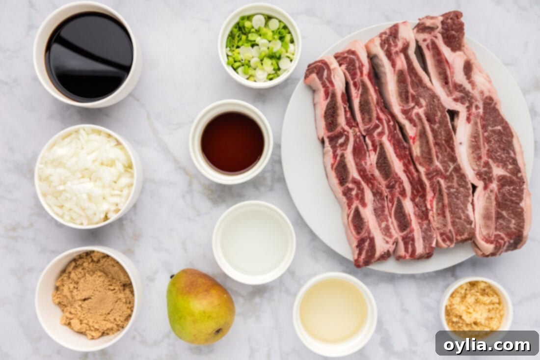 A colorful array of fresh ingredients laid out for Korean Short Ribs marinade, including pears, onions, garlic, and sauces.