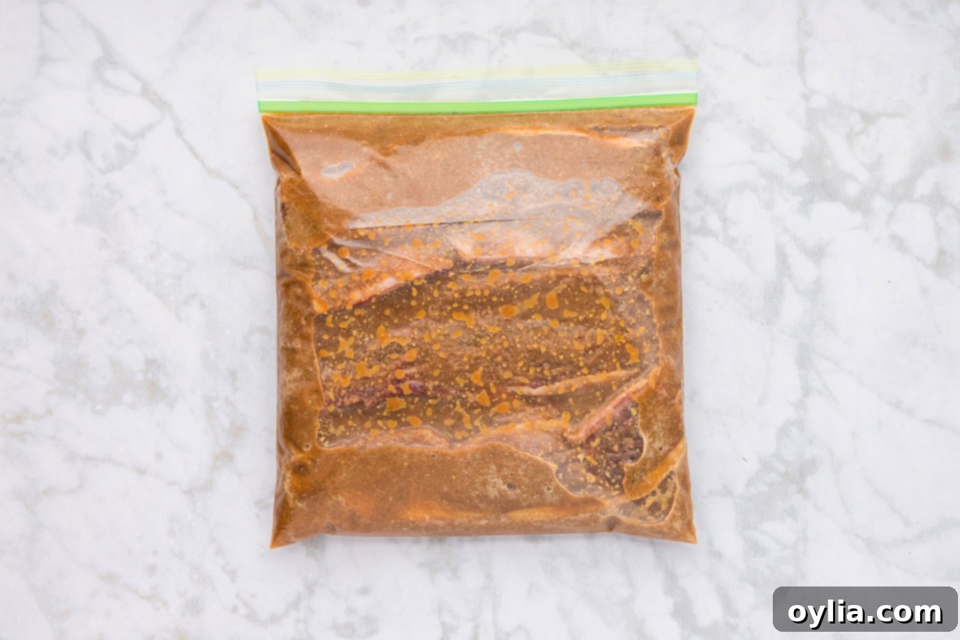 Short ribs soaking in the flavorful Korean marinade inside a sealed plastic bag.