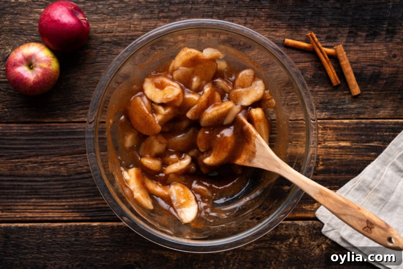 apple pie filling in a bowl with a wooden spoon