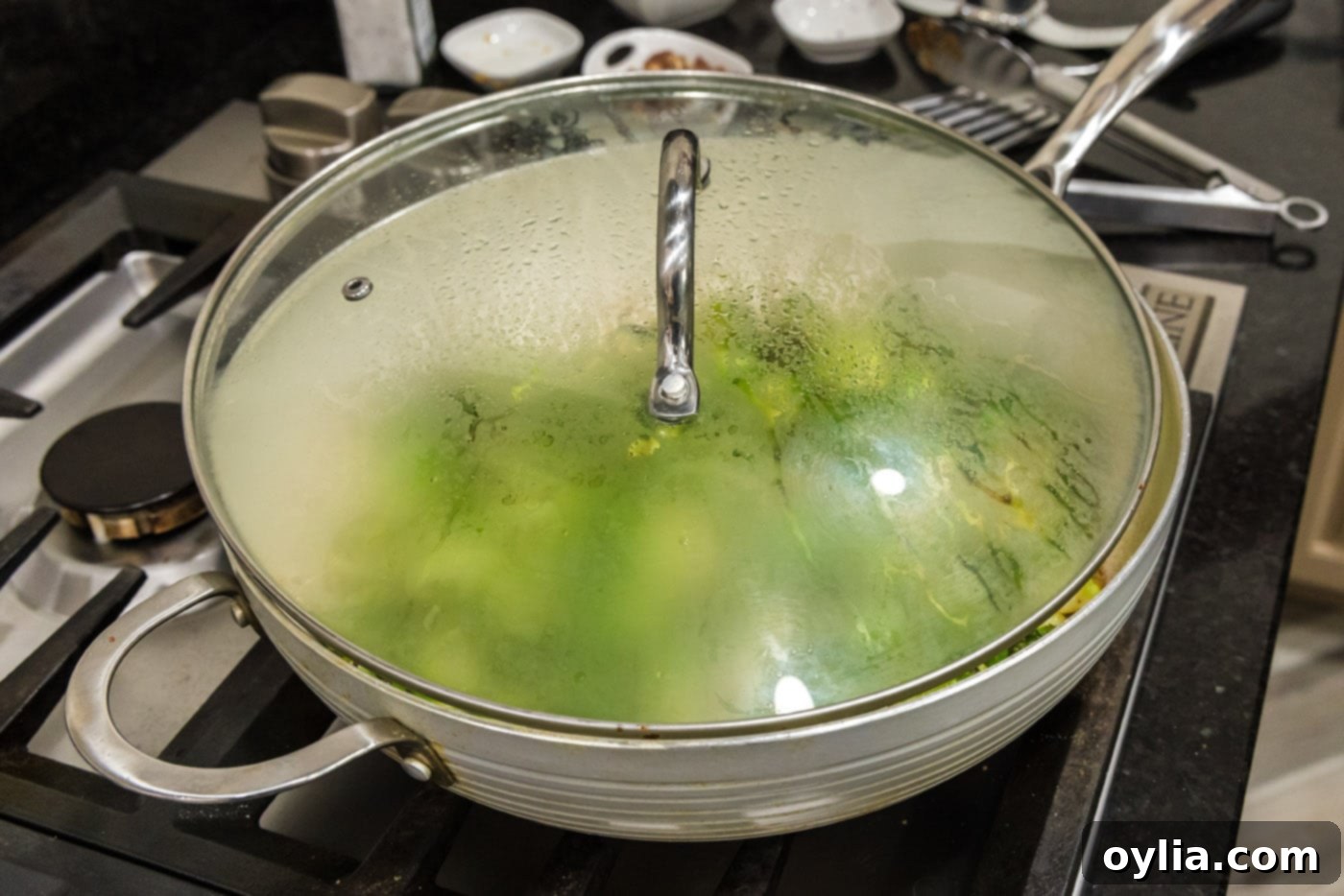 lid over the top of brussels sprouts in a skillet