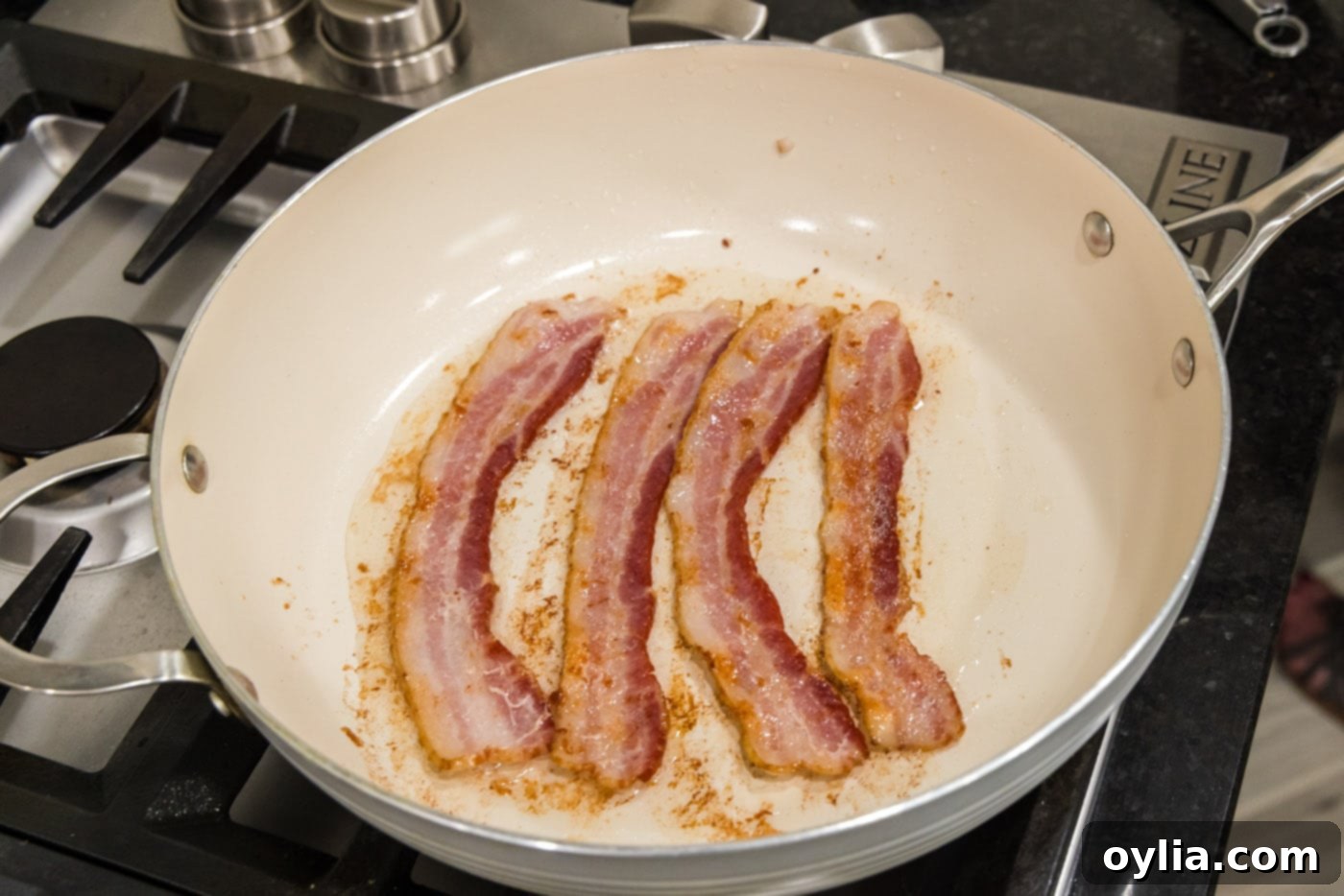 cooked bacon strips in a skillet