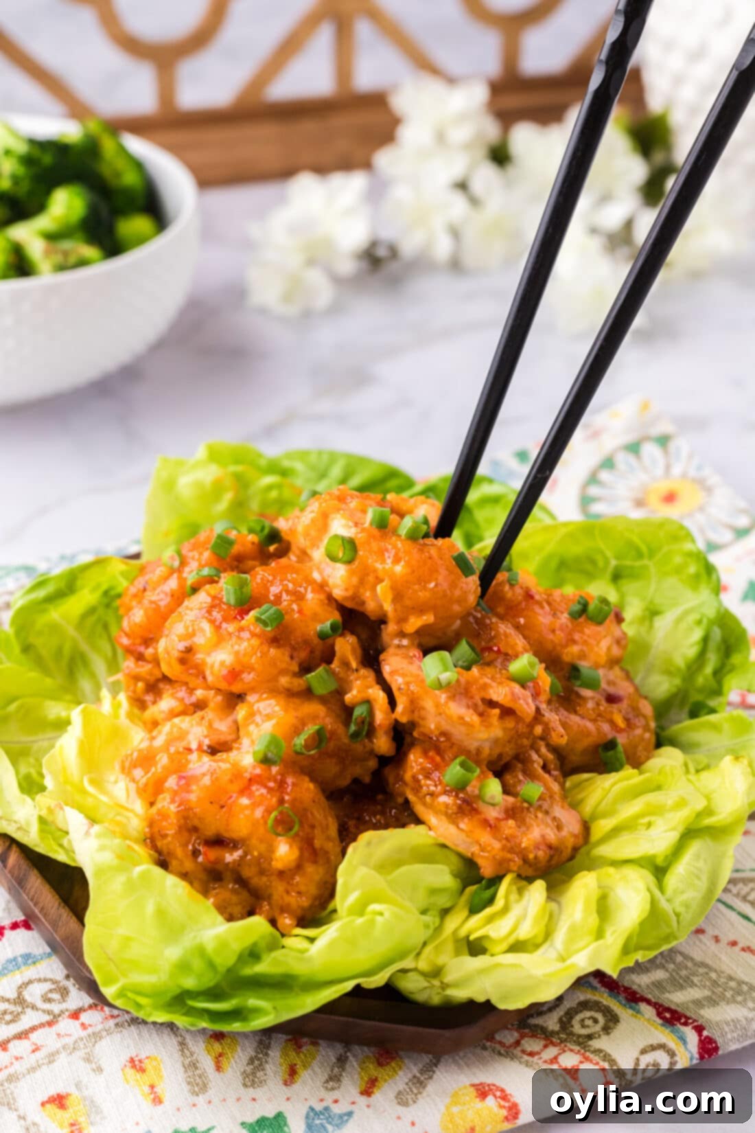 Chopsticks grabbing a piece of Bang Bang Shrimp