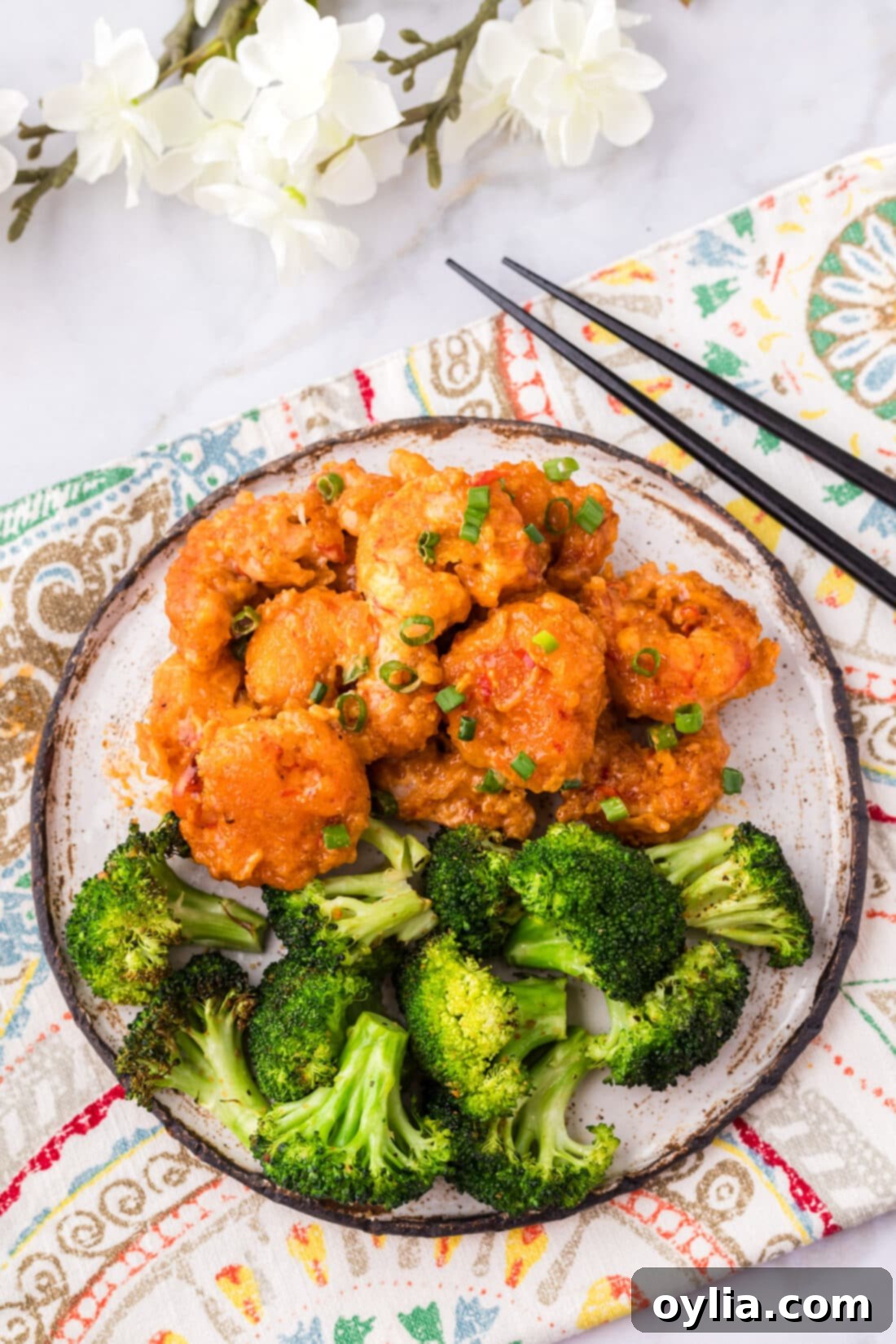 Bang Bang Shrimp on a plate with broccoli 