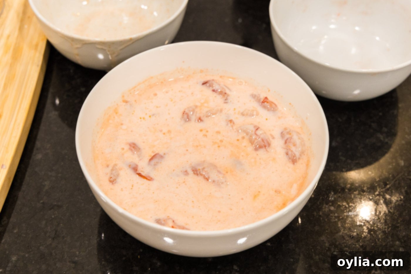 shrimp marinating in buttermilk and hot sauce