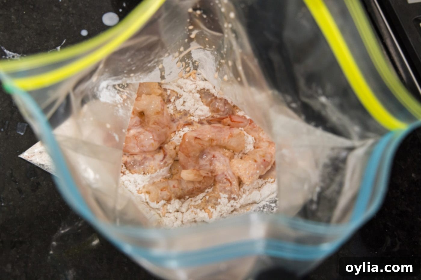 marinated shrimp added to flour in a large bag