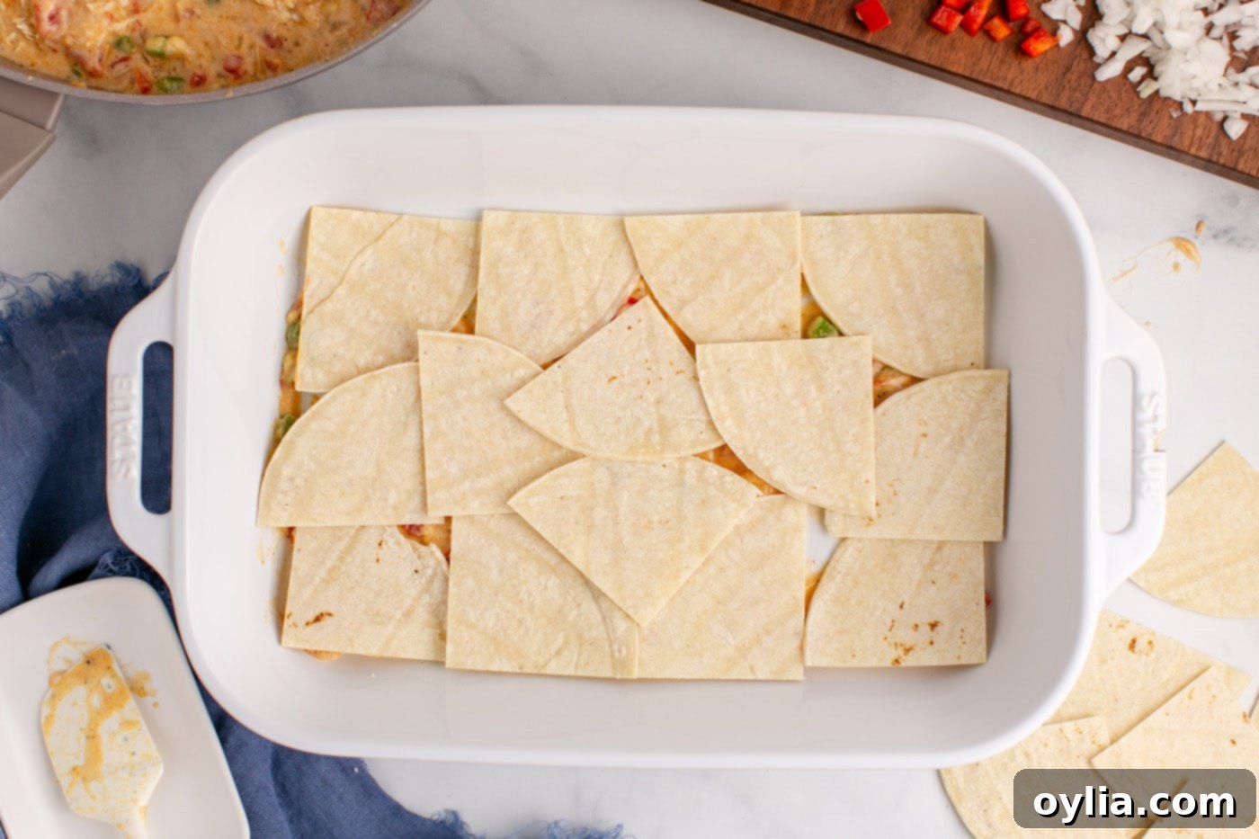 tortilla triangles layered in a baking dish